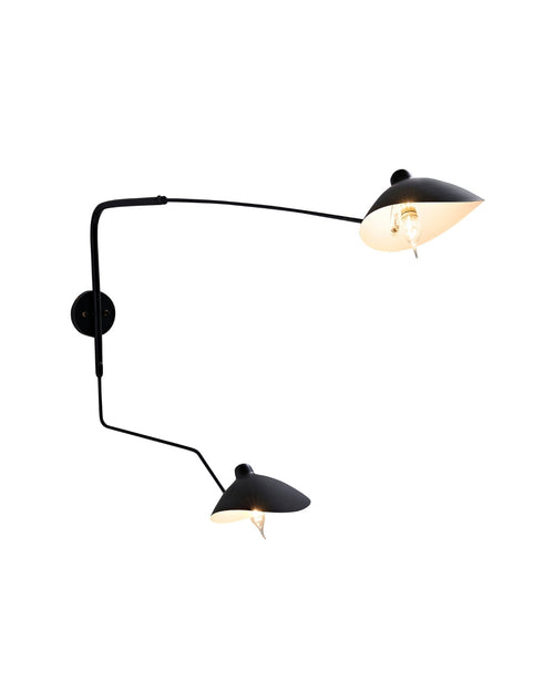Fleur de Noir Wall Sconce with a matte black finish, featuring an elongated sculptural arm and two opposing dome-shaped shades, shown illuminated against a white background.