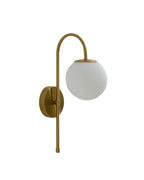 Wall-mounted light fixture with a curved brass arm, round brass wall plate, and a spherical opaque white glass shade.