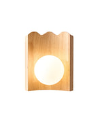 Oak wood wall sconce with a scalloped top edge and a centered round white glass globe.