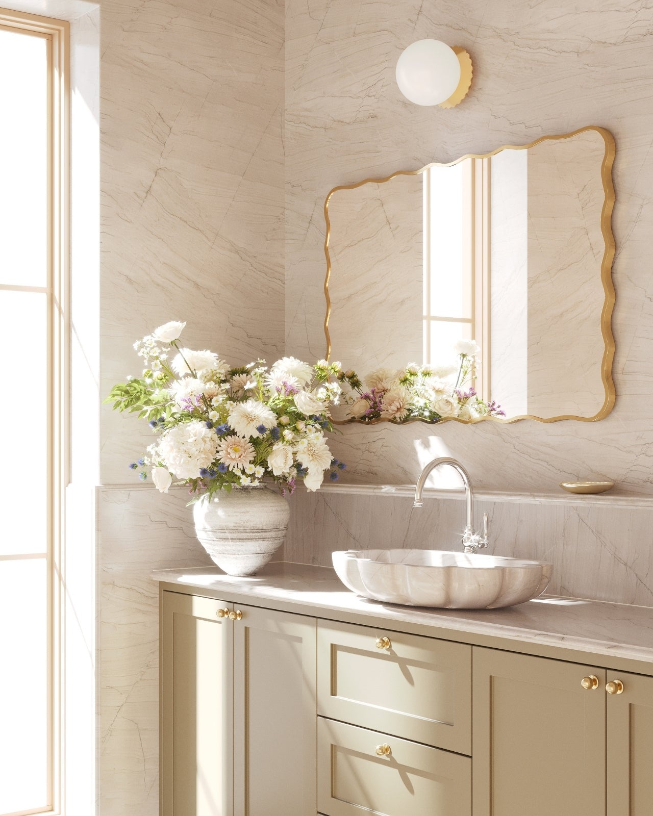 Rectangular wall mirror with a gold frame and softly wavy edges, mounted horizontally above a bathroom vanity.