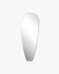Frameless elongated mirror with an organic, asymmetrical silhouette on a white background.