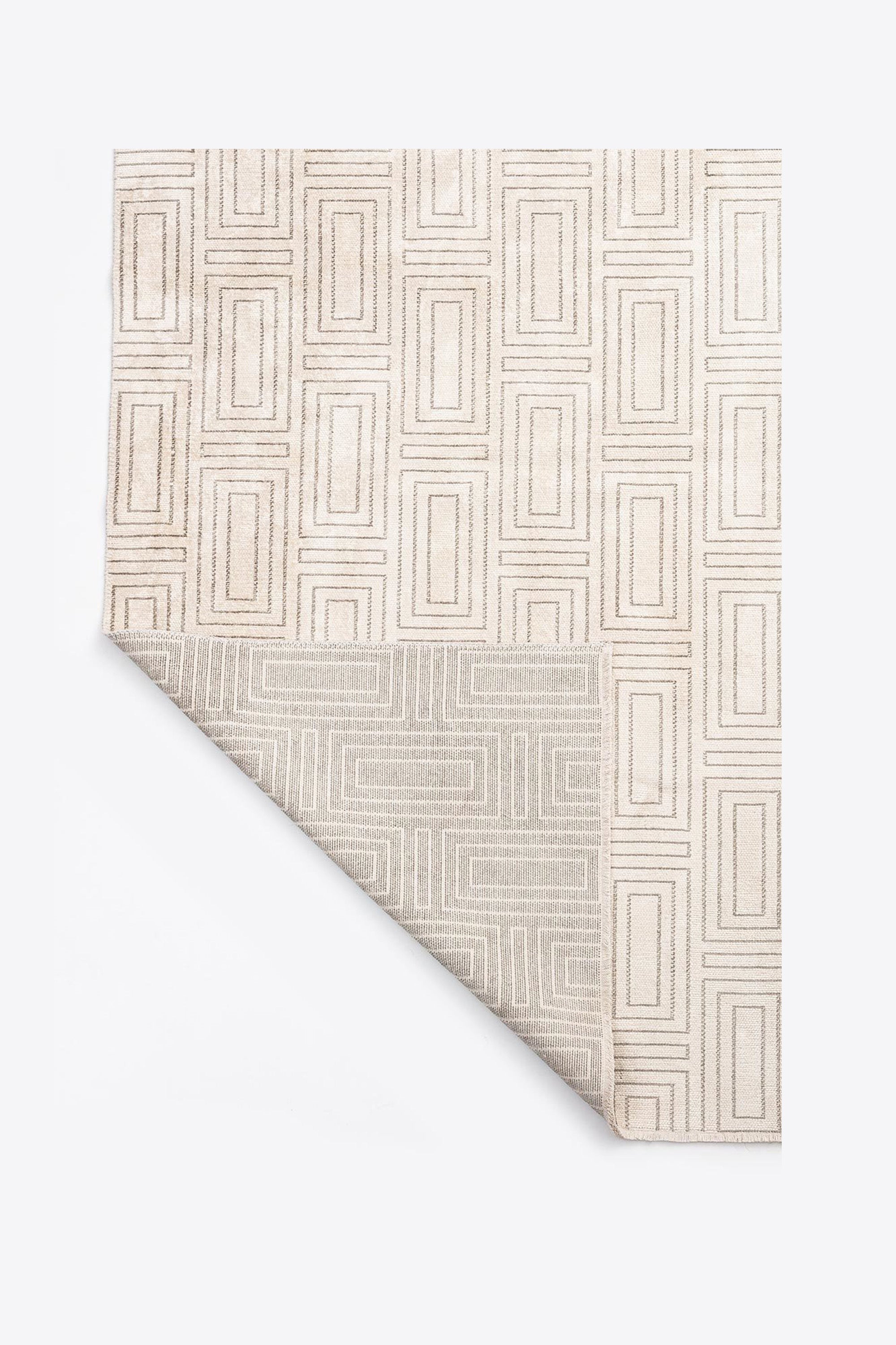 Neutral geometric rug with detailed woven pattern, front and back view.