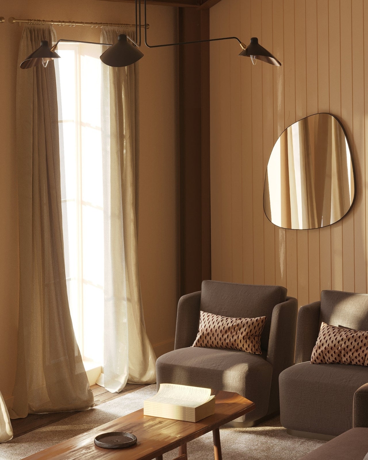 Organic frameless wall mirror with a soft, irregular silhouette, styled in a warm-toned living space above upholstered lounge chairs.