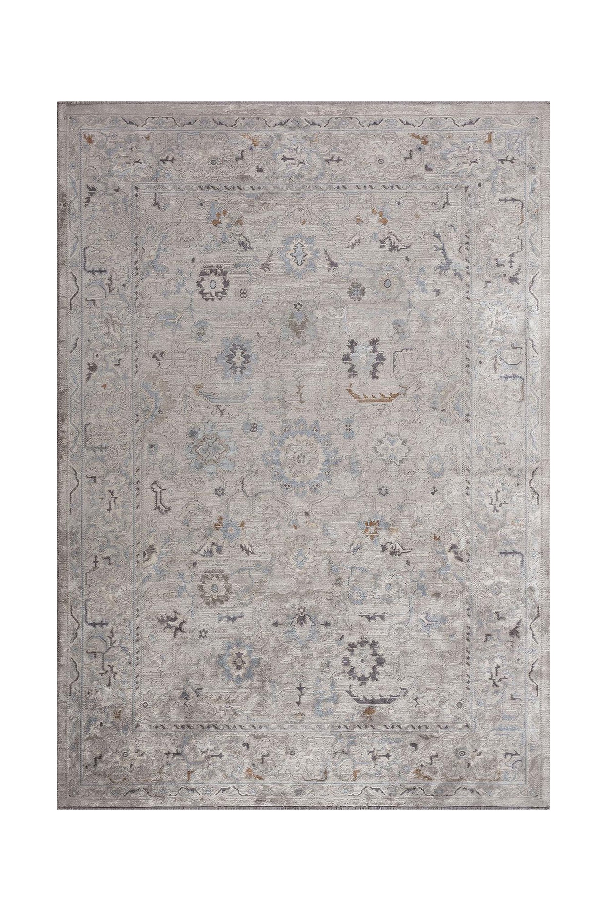 Handcrafted flat-woven rug with a muted gray and blue pattern and subtle vintage detailing.