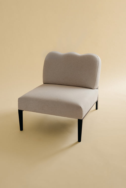 Beige linen upholstered accent chair with a curved backrest and black metal legs.