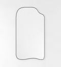 Asymmetrical full-length mirror with an organic shape and thin black frame on a white background.