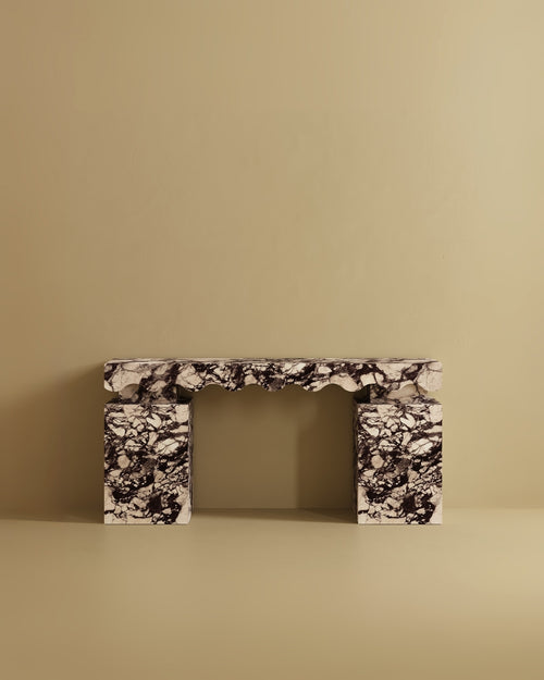 Console table crafted from Calacatta marble, featuring a rectangular top with a sculpted edge and two solid block legs.