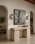 Decorative console table in a living room with a large abstract painting on the wall.