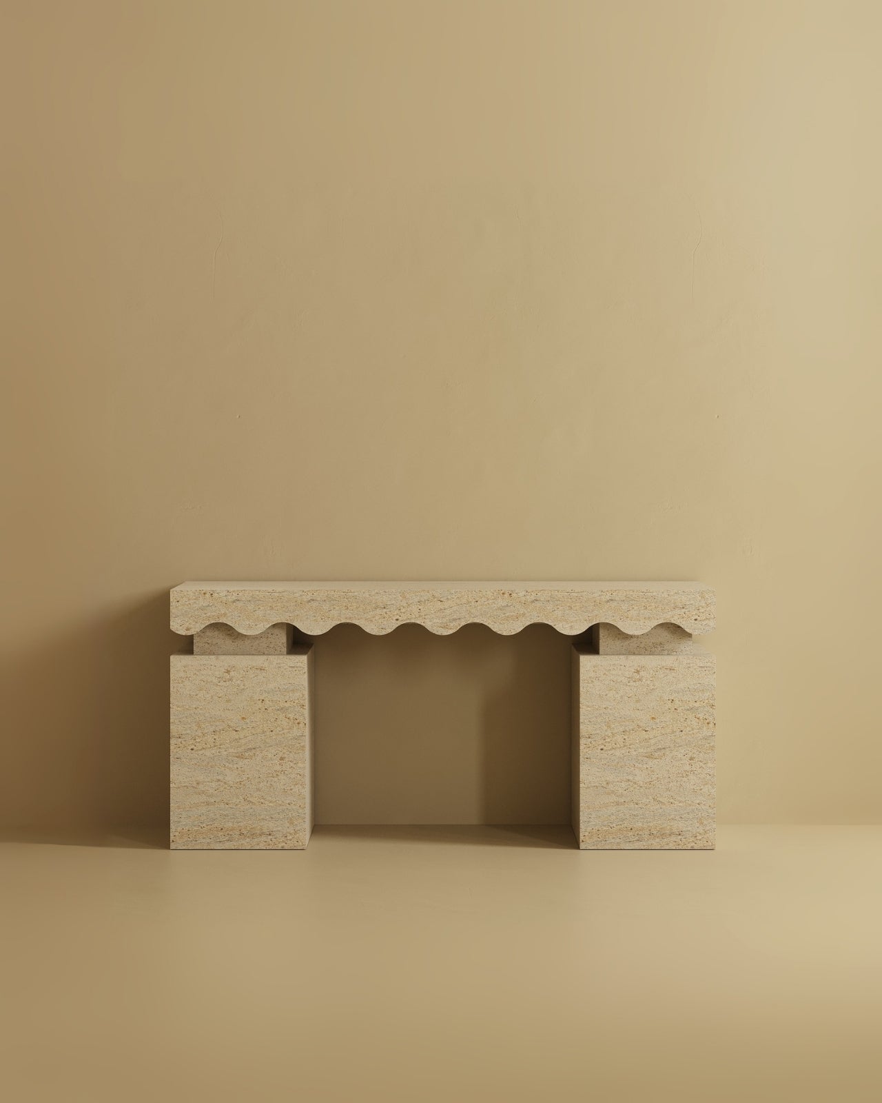 Travertine console table with a rectangular top featuring a scalloped carved edge and two solid block legs.