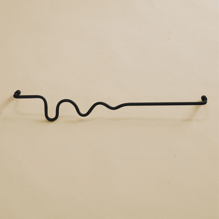 Black-colored towel bar with a wavy organic shape, shown in a studio setting on a neutral background.