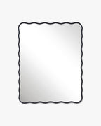 Rectangular wall mirror with a black frame and softly wavy edges, shown in a vertical orientation.