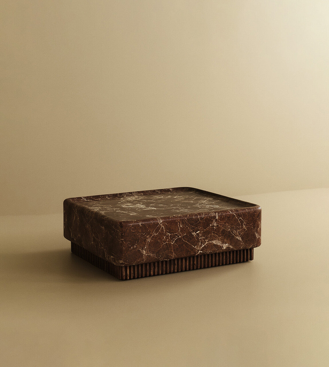 Square coffee table crafted from dark brown marble with subtle veining, featuring a solid block top and a low, ribbed base.