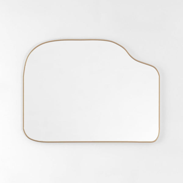 Asymmetrical brass-framed mirror with a horizontal orientation against a white background.