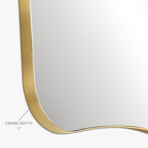 Close-up view of a mirror corner showing a brass-colored frame with a 1-inch frame depth.