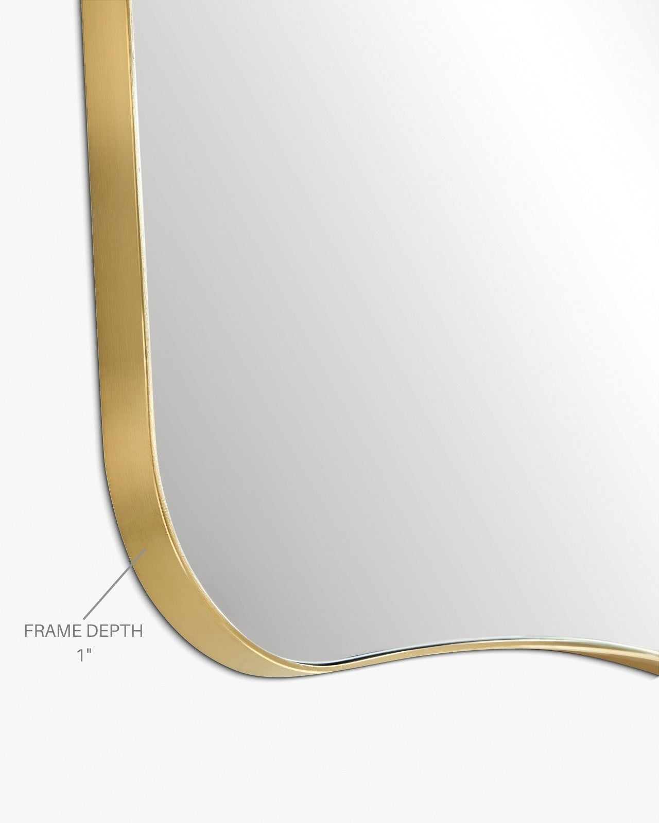 Close-up view of a mirror corner showing a brass-colored frame with a 1-inch frame depth.