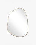 Asymmetrical mirror with an organic shape and a thin brass-colored frame on a white background.