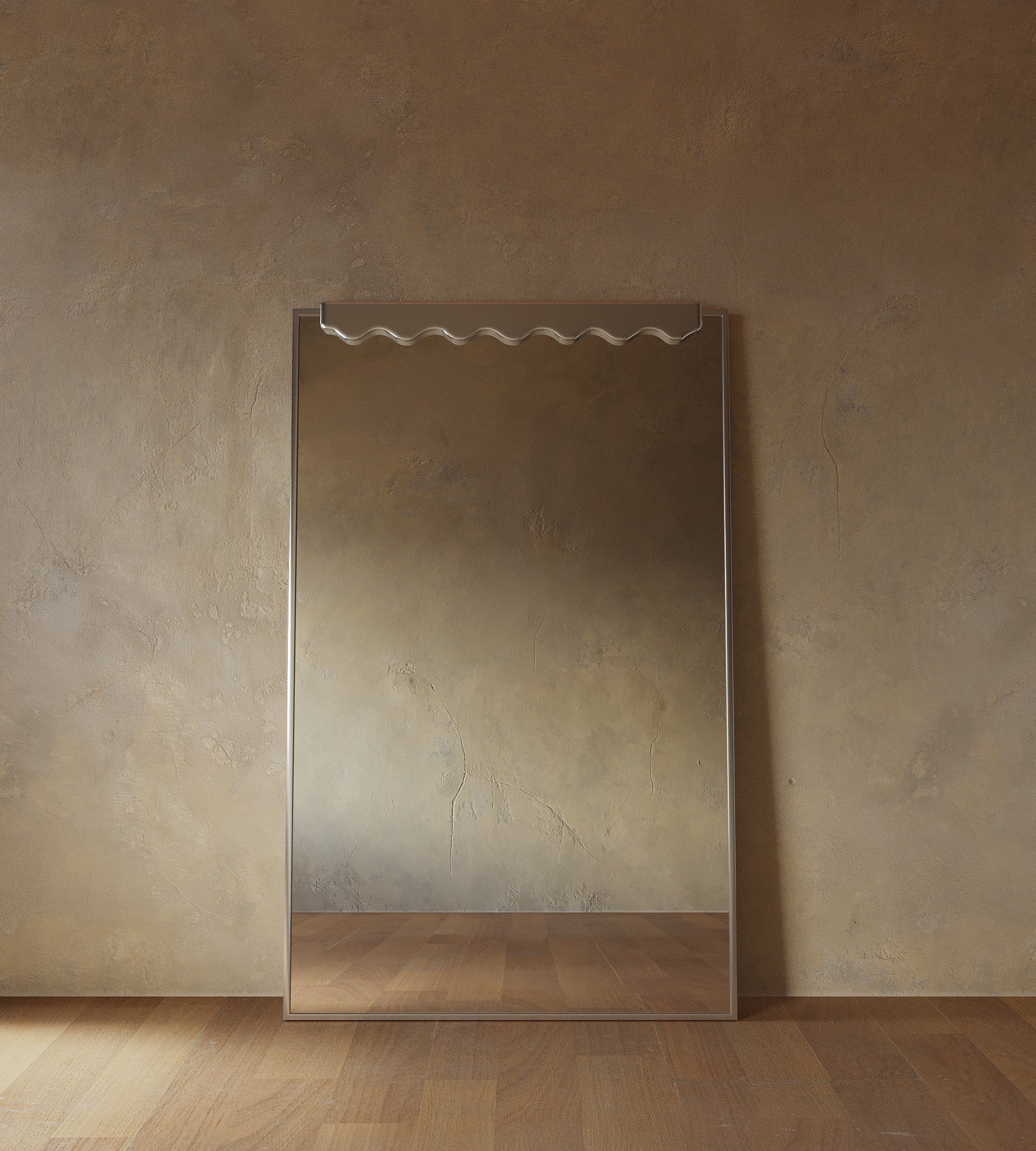 Full-length rectangular mirror with a slim stainless steel frame and a subtle wave-shaped detail at the top, leaning against a textured beige wall on a wooden floor.