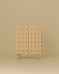 Wooden storage cabinet with a sculptural front featuring evenly spaced rounded wooden spheres and a clean rectangular form.