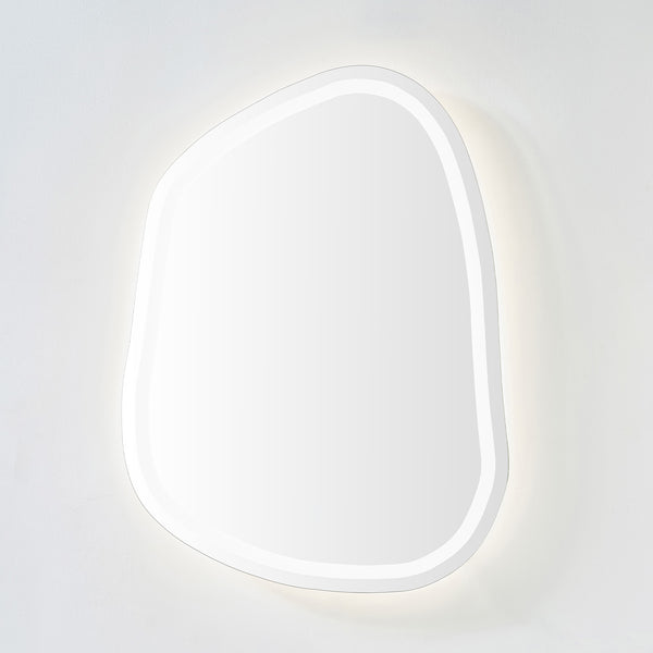 Organic-shaped LED mirror with soft neutral backlit glow on a light-colored wall.