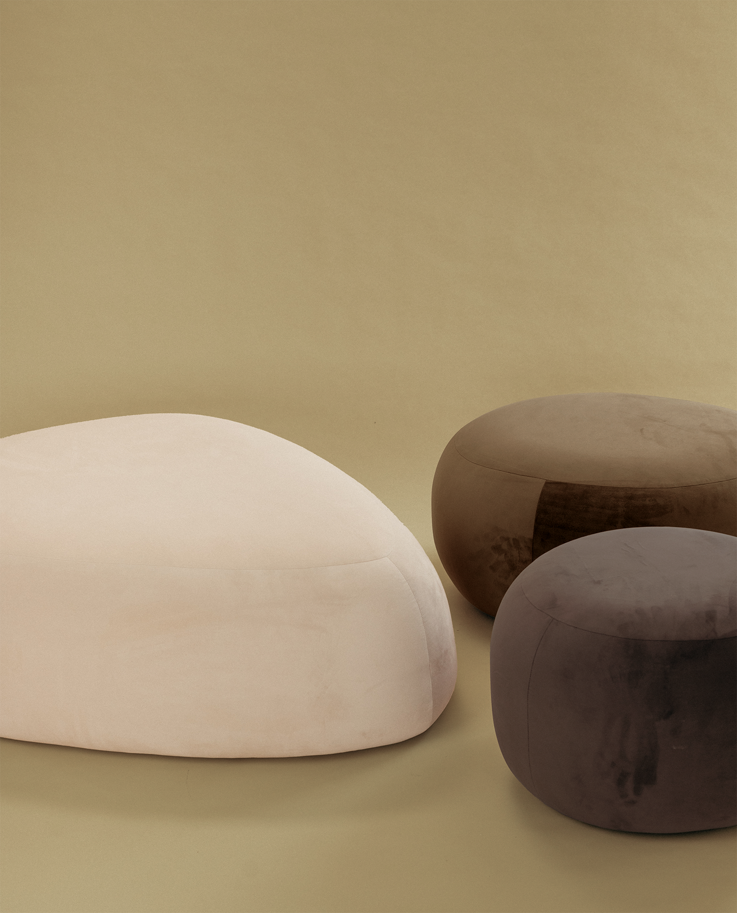 Pebble Ottoman set with three upholstered ottomans in cream and brown tones, featuring soft rounded forms on a neutral background.