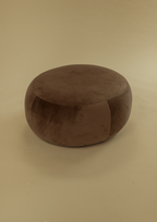 Large Pebble Ottoman in brown upholstery with a rounded silhouette, shown from a front angle on a neutral background.