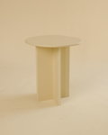 A minimalist side table featuring a round tabletop and three vertical legs in a light cream finish, photographed in a neutral studio setting.
