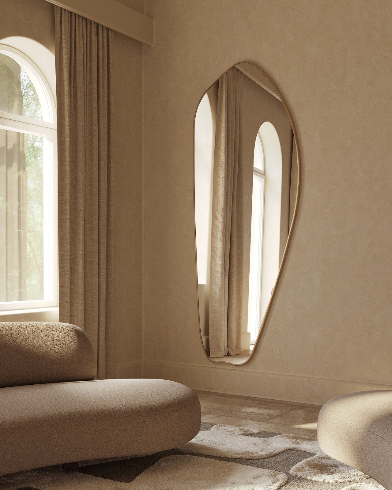 Asymmetrical brass wall mirror in a softly lit living room.