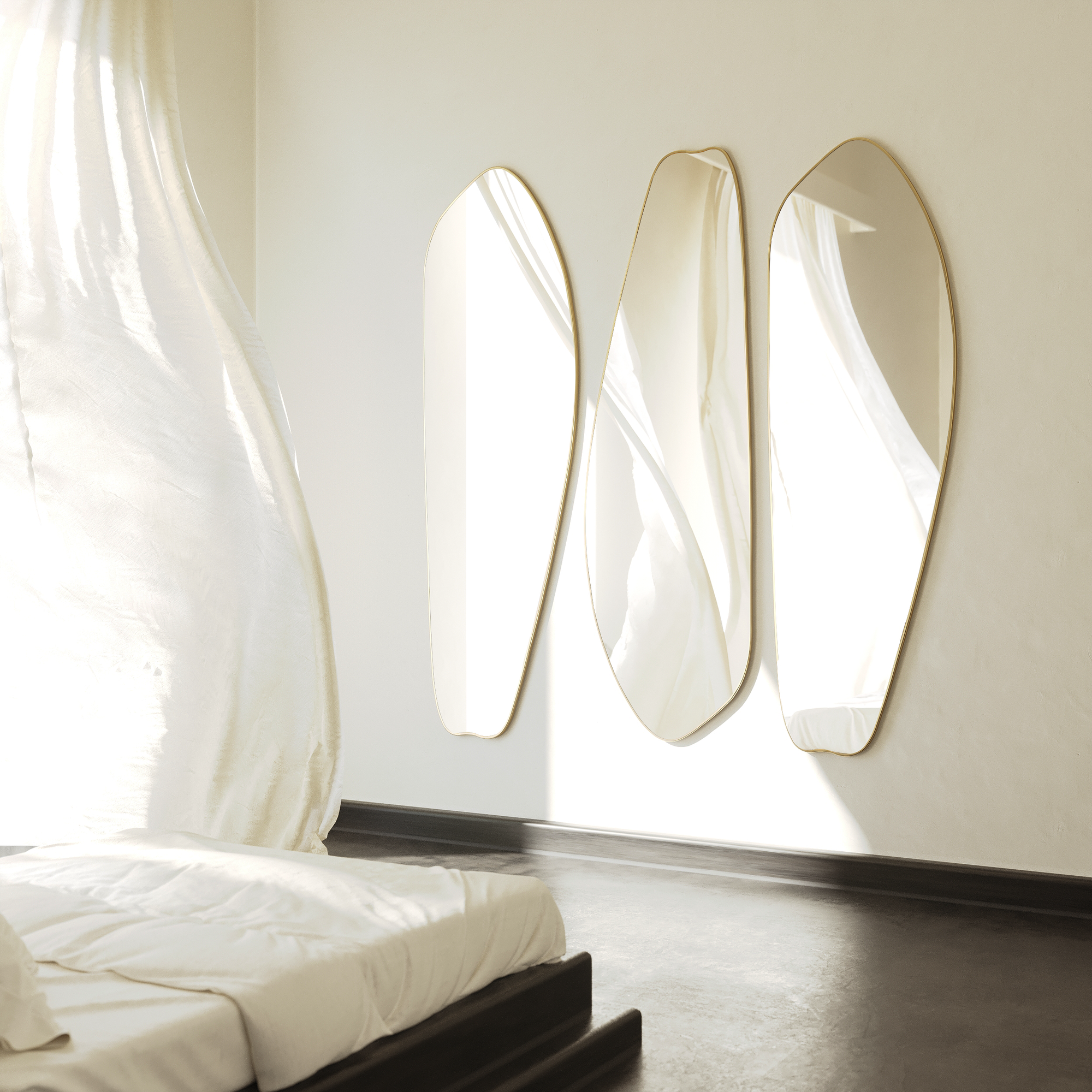 Three asymmetrical brass full length mirrors styled as a set in a sunlit bedroom.