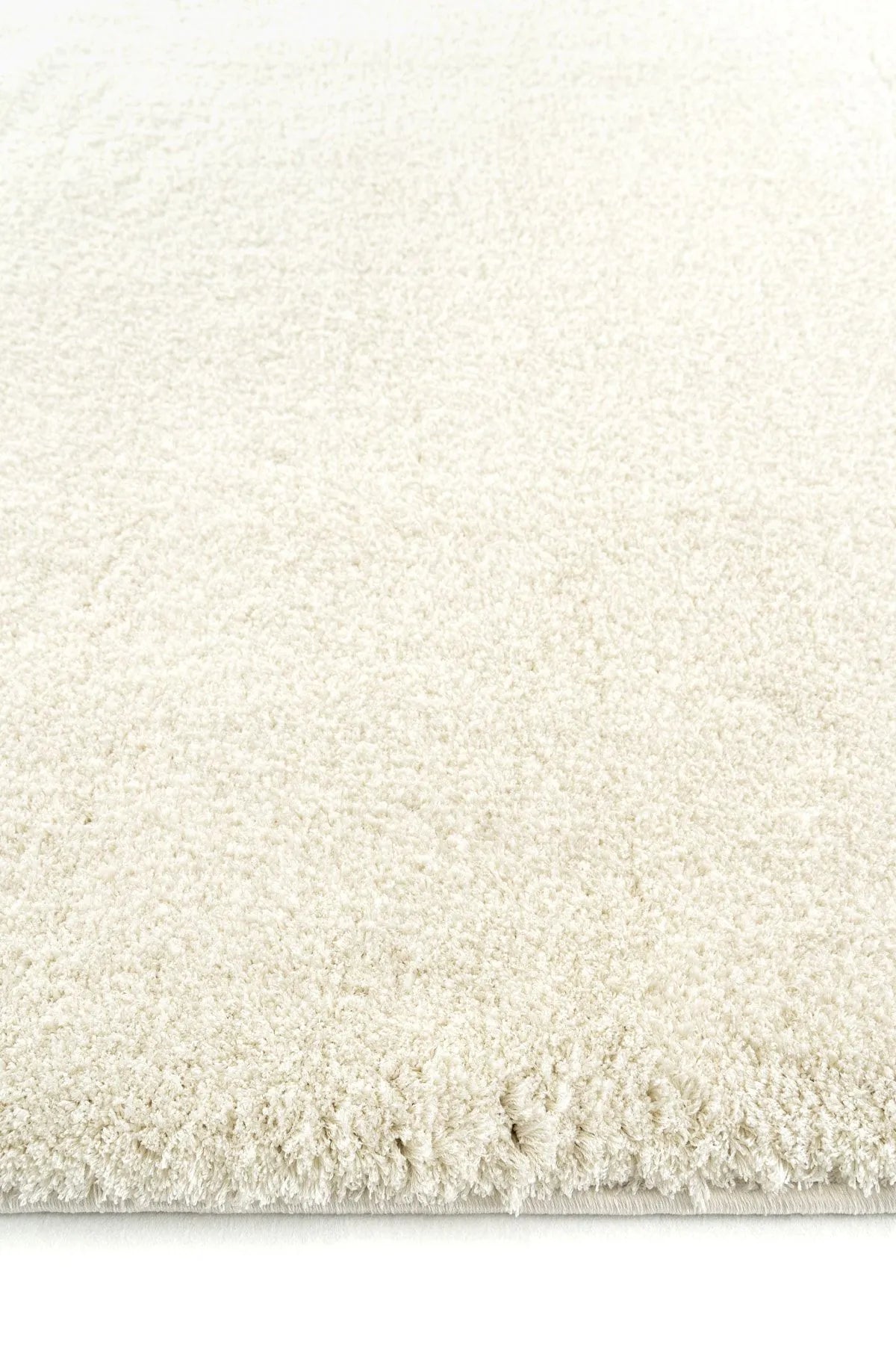 Close-up of beige plush rug with thick, soft pile.