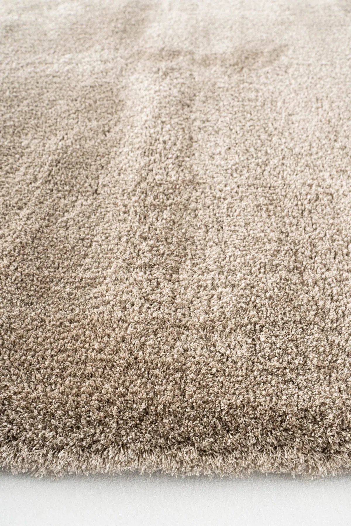 Close-up of a brown plush rug showing thick pile.