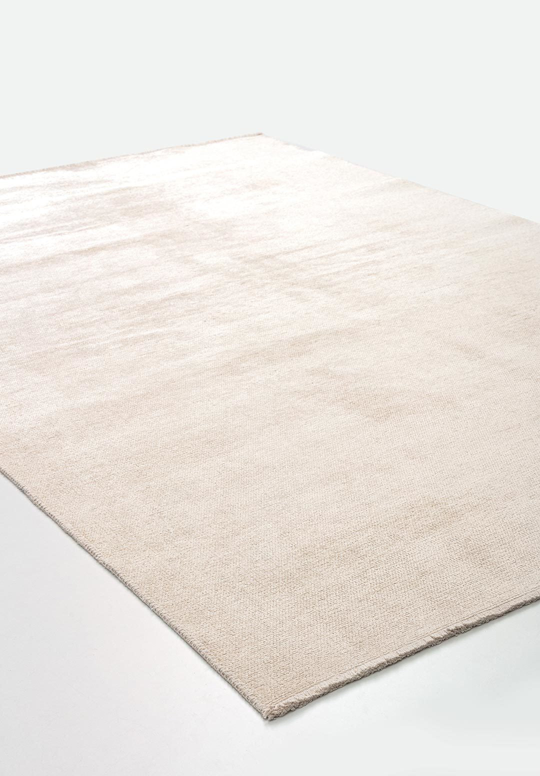 Almost white flat-woven area rug.