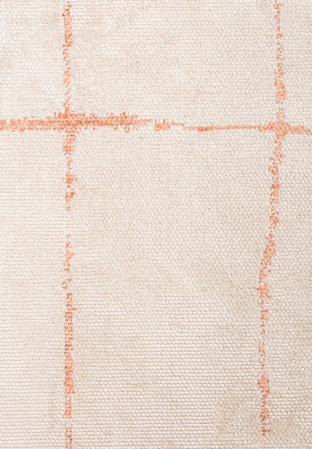 Close-up of a flat-woven beige rug with subtle blush grid lines and textured weave.