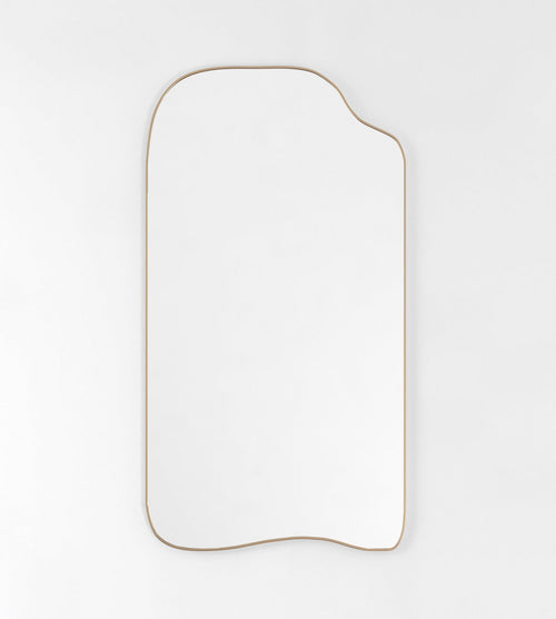 Asymmetrical full-length mirror with an organic shape and thin brass-colored frame on a white background.