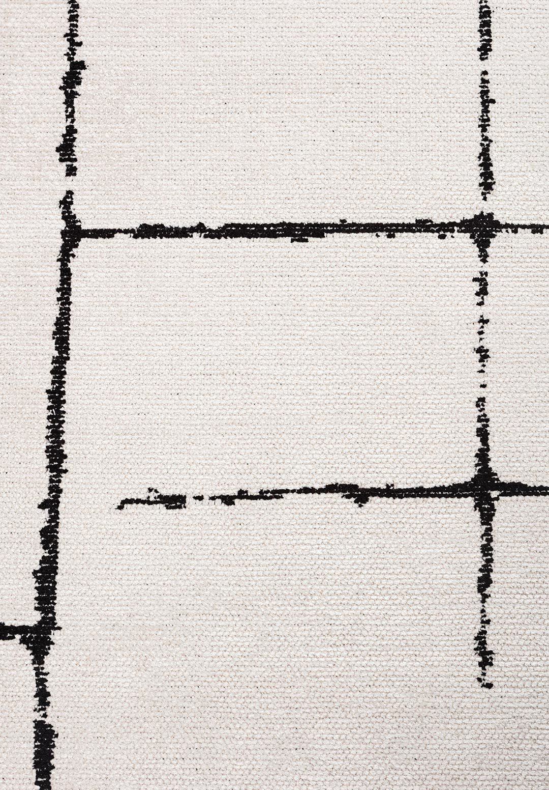 Close-up of a beige rug with black hand-drawn grid lines.