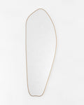 Asymmetrical full-length mirror with a brass frame on a white background.