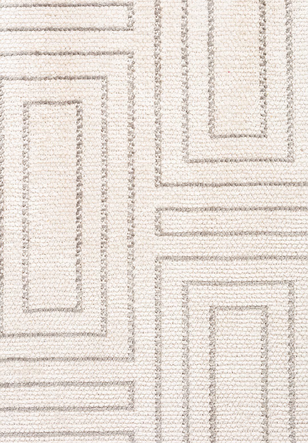 Close-up of geometric flat-woven rug texture.