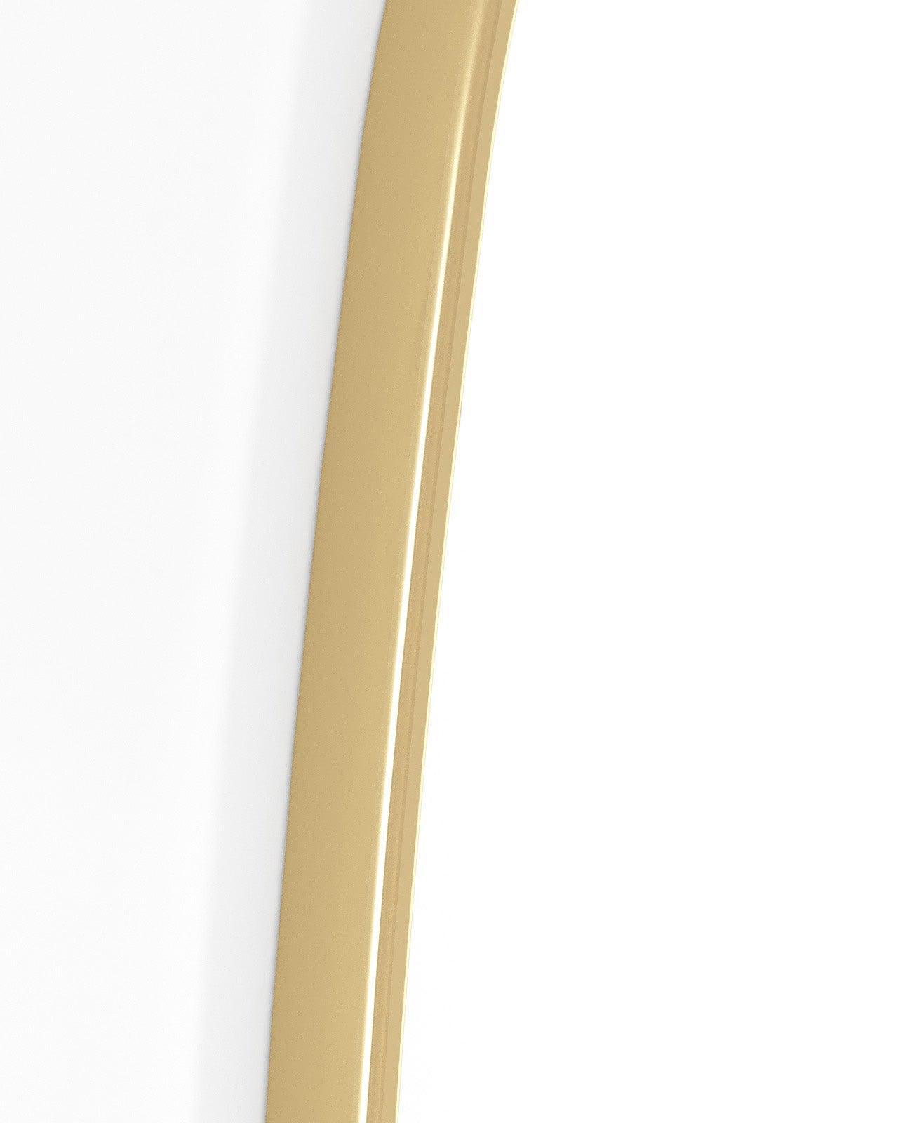 Close-up detail of a brass mirror frame edge against a white background.