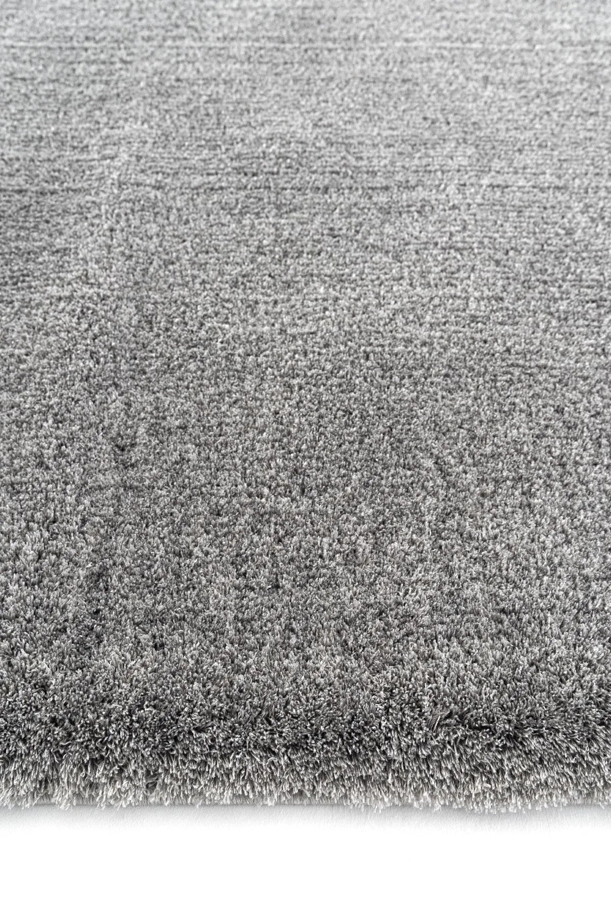 Light gray plush rug surface with dense, soft pile texture.