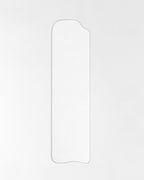 Asymmetrical full-length mirror with an organic silhouette and thin frame, shown against a plain white background.
