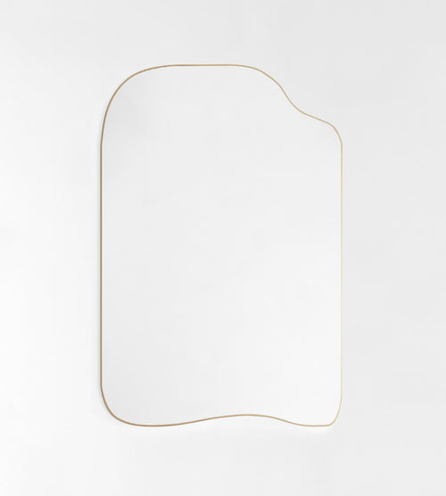 Asymmetrical wall mirror with a thin gold-colored frame on a white background.